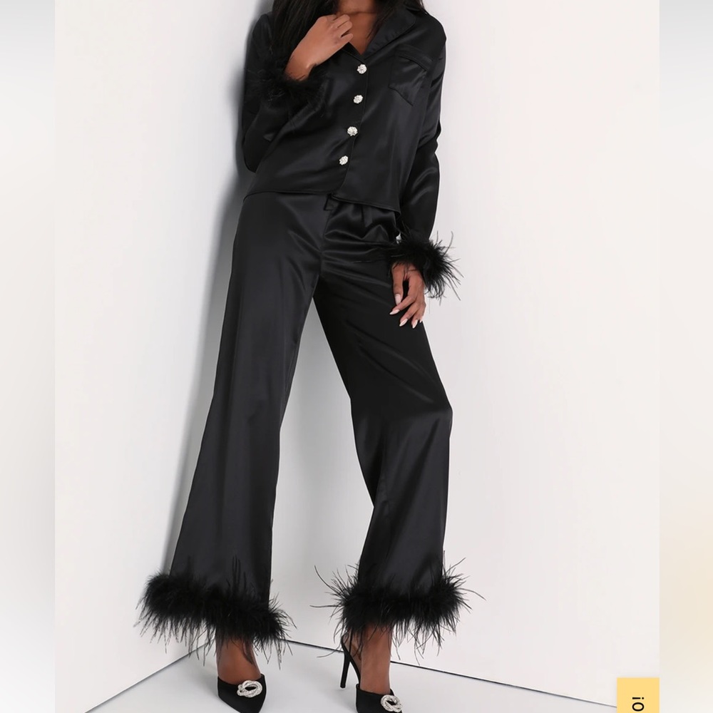 Black silk pajamas with feathers around the wrists and ankles